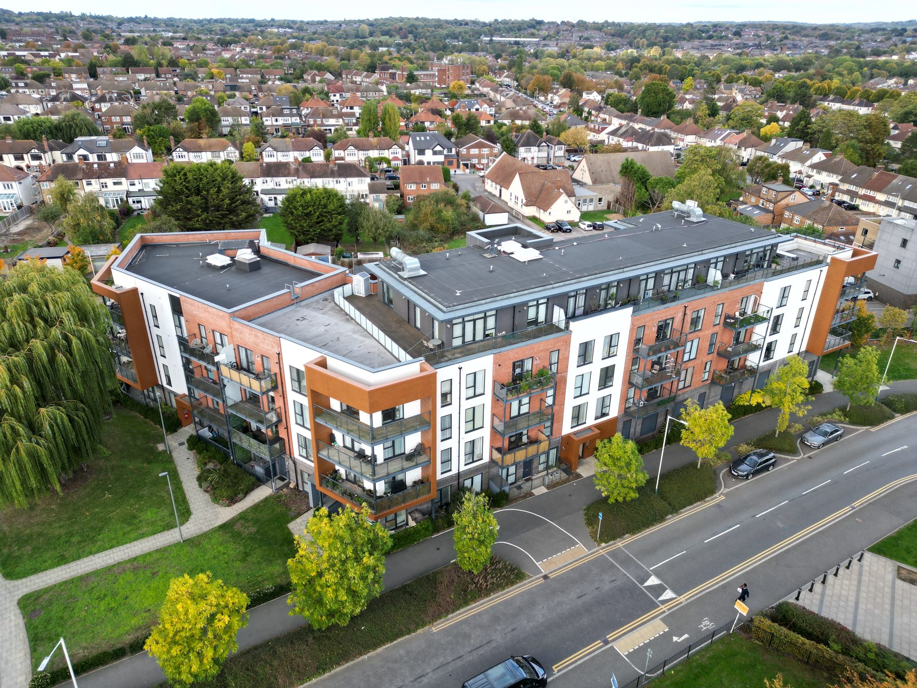 Apartment building with terraces and balconies, autumn aerial close-up, Romford