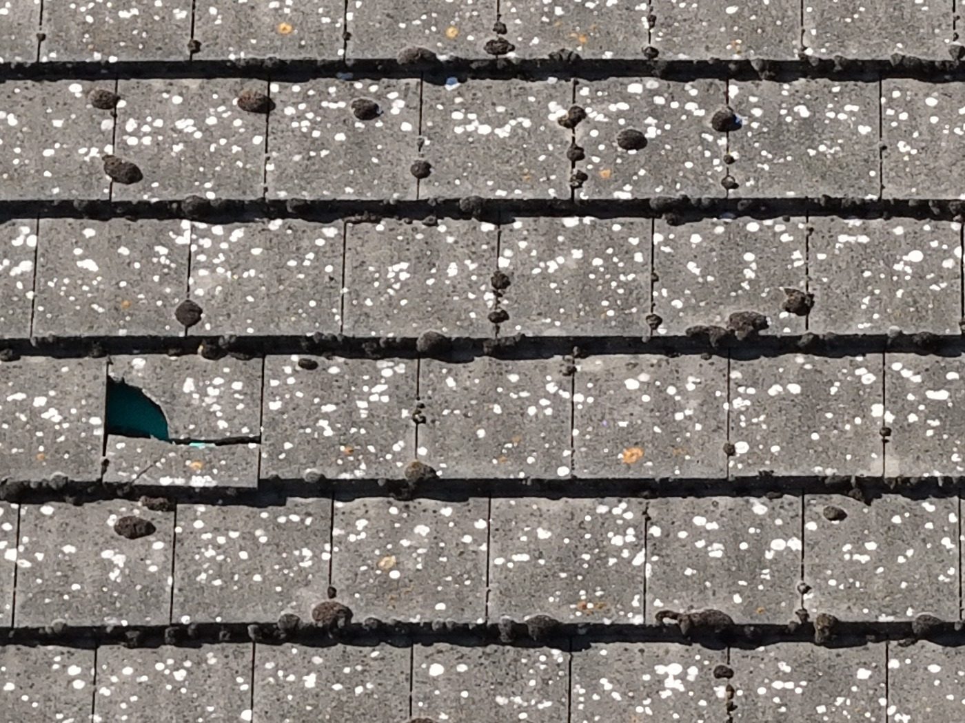 Missing section of tile with underlay exposed